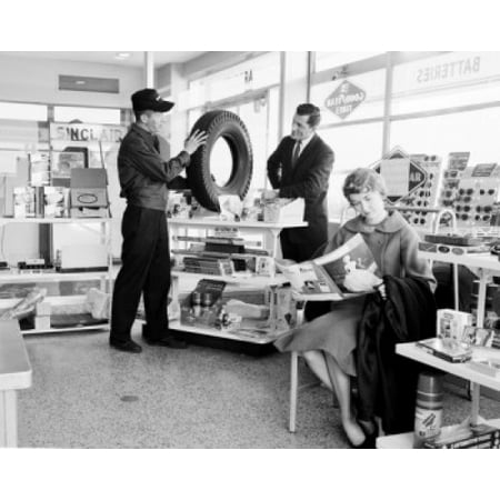 - Man buying tire and woman reading magazine Poster Print