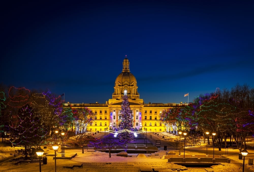 Alberta Legislature building illuminated and a Christmas tree with