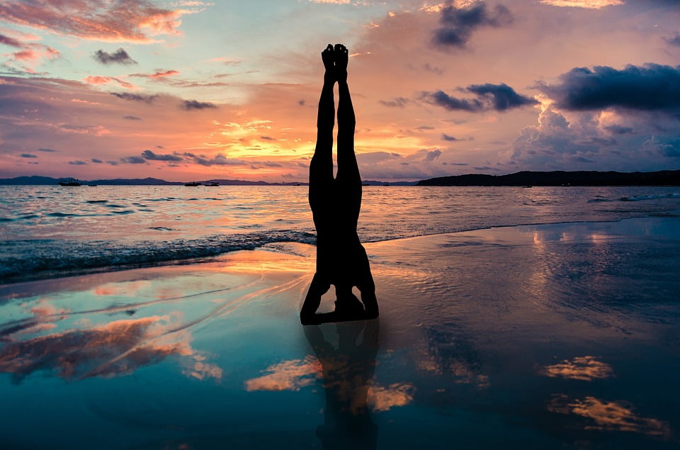 Laminated Poster Yoga Stand In Hands Silhouette Sunset Beach Laminated Poster Yoga Stand In Hands