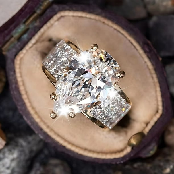 Anillo de compromiso chapado en oro macizo con circonitas en forma de pera para mujer.