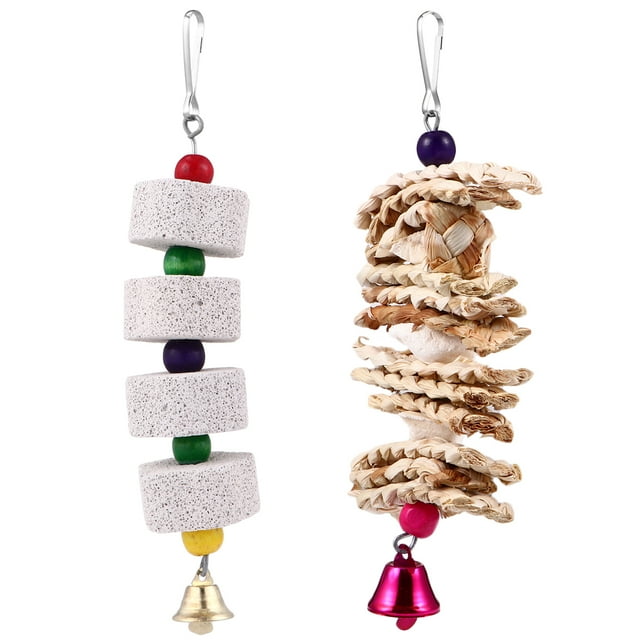 2Pcs Pet Bird Parrots Toy Bite Resistant Teeth Grinding Chewing Hanging Stones. The image shows two hanging bird toys, one made of stacked volcanic stone discs in khaki with colourful wooden beads and a gold bell, and the other featuring woven corn flakes and cuttlefish bone with a pink bell. Both toys are designed for chewing, teeth grinding, and calcium supplementation, with durable, bite-resistant materials.