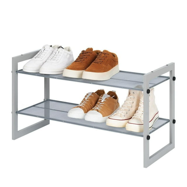 Mainstays Two-Tier Stackable Shoe Rack with mesh silver shelves and light grey wood frame, holding four pairs of shoes including white sneakers, brown casual shoes, and beige high-top sneakers. Ideal for entryway or mudroom shoe storage and organization, stackable design allows easy expansion and breathability.