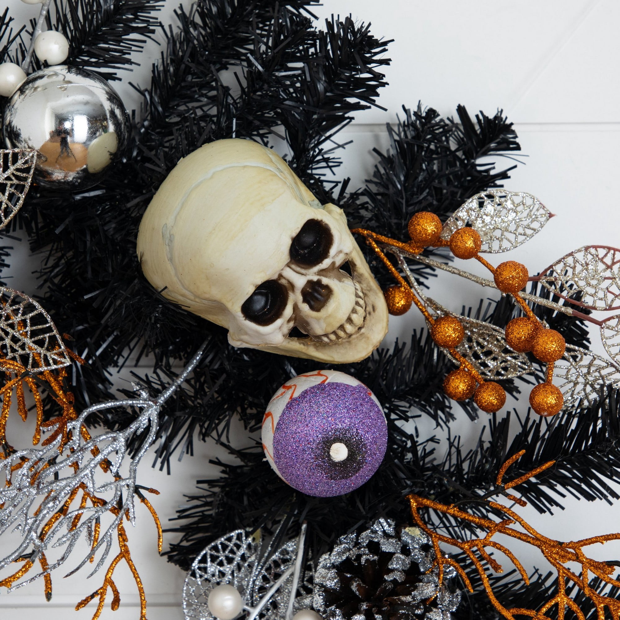 6ft. Artificial Halloween Black Garland with Skulls, Eyeballs and Spiders