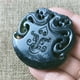 thumbnail image 1 of Jade pendant, made of black ink jade with openwork snake pattern, translucent green under light, magnetic jade., 1 of 4