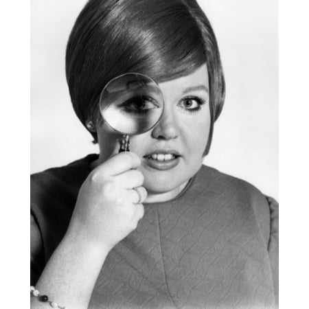 Studio portrait of teenage girl looking through magnifying glass Poster Print