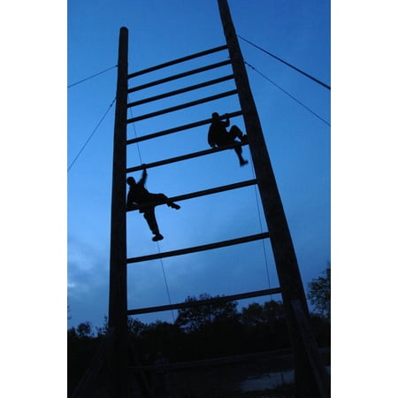 LAMINATED POSTER Two pararescue trainees run through an obstacle course after a full day of physical training during Poster Print 24 x