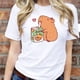 thumbnail image 3 of Playera Blusa Divertida De Capybara Tomando Jugo Ropa De Mujer Capibara Color Blanco Talla Grande Marca Emil SaEs, 3 of 4