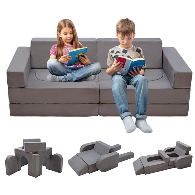 sofá modular de juegos para niños kinevoli, sofá seccional para niños pequeños, gris — vista frontal centrada de sofá seccional de 10 piezas con respaldo recto, apoyabrazos cuadrados y cojines de espuma recubiertos en tela gris; dos niños sentados leyendo muestran escala; configuraciones inferiores muestran fuerte con arcos, cama baja desplegable y cojín de suelo, ideal para juego, lectura o siestas.