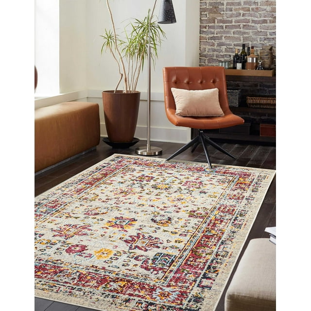 ECARPET Aldora Traditional Area Rug for Living Room featuring vintage-inspired floral and geometric patterns in red, yellow, blue, and beige tones on dark hardwood flooring, paired with a brown leather swivel chair, a beige pillow, a tall potted plant, and a modern floor lamp, suitable for adding warmth and texture to bedrooms, dining rooms, and entryways.