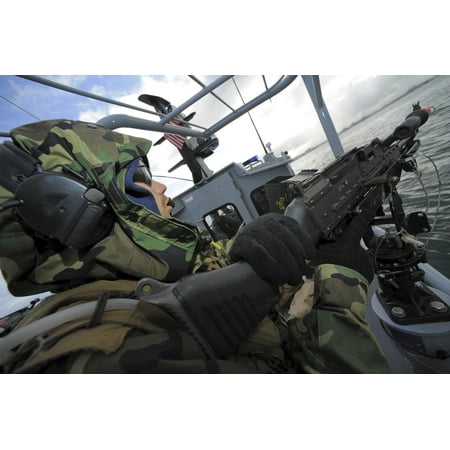A boat crewman gunner mans an M-240B machine gun aboard a rigid-hull inflatable boat Canvas Art - Stocktrek Images (35 x 23)