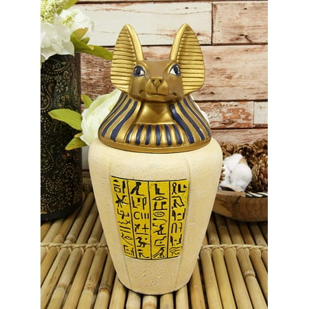 Ebros Ancient Egyptian God of The Dead Anubis Classical Canopic Jar 10.5  Tall • This exotic Anubis Canopic Jar measures approximately 10.25 Tall and 5.5  wide. It weighs about 4.5 pounds. • This exotic Anubis Canopic Jar is made of composite resin  hand painted and polished individually. The sculpture boasts of the anubis head in gold and royal blue with a faux pottery body with unique Egyptian hieroglyphs on the front with gold background. • Ancient Egyptians used canopic jars to store internal organs during the mummification process  but you can put other things in them too that is less  dark . It makes perfect container for candies  treats  as an urn for small pets and other knick knacks you can think of. • Anubis was the god of embalming and the dead. Since jackals were often seen in cemeteries  the ancient Egyptians believed that Anubis watched over the dead. Anubis was the god who helped to embalm Osiris after he was killed by Seth. • This is an Ebros exclusive collection. It comes with our Ebros Gift Satisfaction Guarantee when sold by Ebros Gift. Props and soda can in photos are not included with the item.