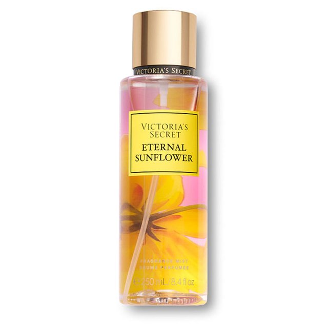 fragrance mist eternal sunflower para mujer de victoria's secret 250ml Botella cilíndrica frontal de fragancia en spray 250 ml con tapa metálica dorada, etiqueta cuadrada amarilla con texto "Victoria's Secret Eternal Sunflower", líquido rosado y detalles florales impresos en el frasco; fragancia floral para mujer, a menudo usada como mist corporal ligero.
