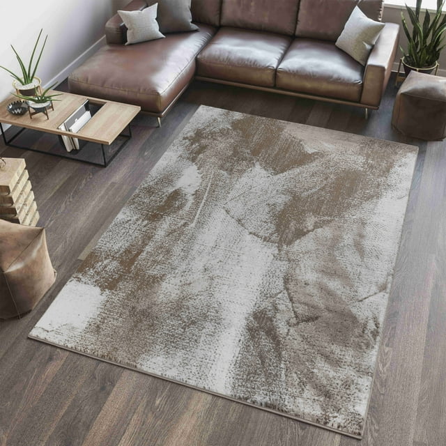 Abstract modern indoor area rug from Rug Branch Sakarya Collection featuring brown and beige tones on hardwood floor under a leather sectional sofa.