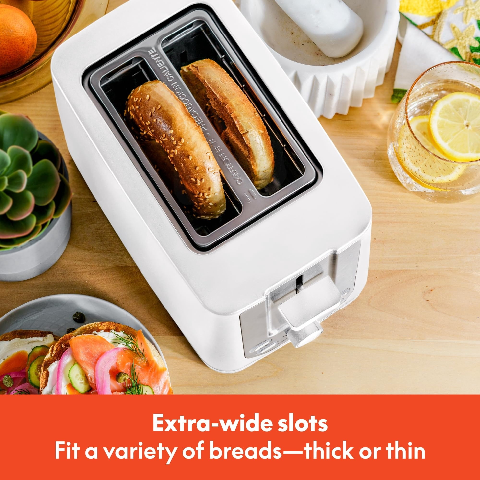 Double-slot toaster with automatic shut-off - extra-wide slots, removable crumb tray, and cancel, defrost, and reheat functions - can toss bread, bagels, and waffles.