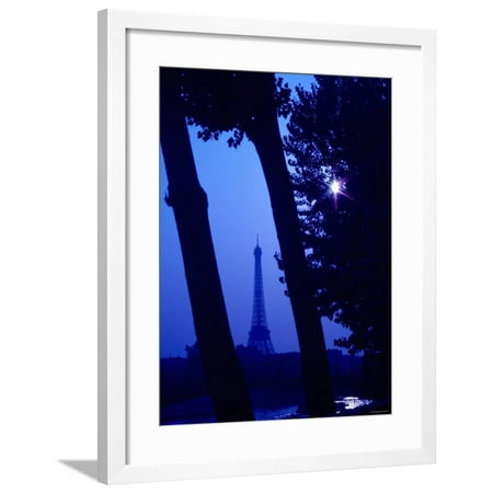 View of Eiffel Tower Landmark Through Tree Trunks at Night with Lens Flare from Shining Moon Framed Print Wall (Best View Of Eiffel Tower At Night)