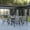 Gray, variant on Emma + Oliver Seven Piece Patio Table Set with 31.5" x 55" Metal Table with Tempered Glass Top and 6 Red Flex Comfort Stacking Chairs
