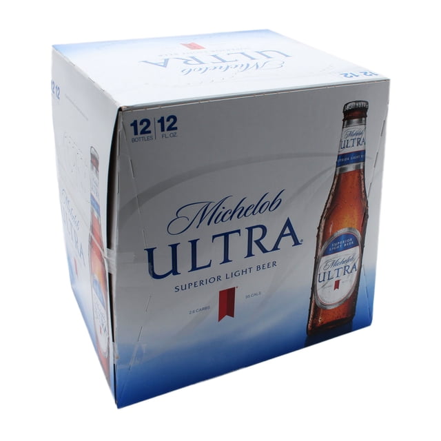cerveza importada michelob ultra 12 botellas de 355 ml c/u Caja 3/4 frontal blanca y azul que contiene 12 botellas; se aprecia una botella marrón con etiqueta blanca y azul con texto 'ULTRA'. Venta solo para mayores de 18 años.