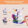 thumbnail image 3 of Rotating acrylic display featuring a unicorn with a Trans Rights sign on glitter grass adorned with translucent resin layers and falling transgender flags, 3 of 8