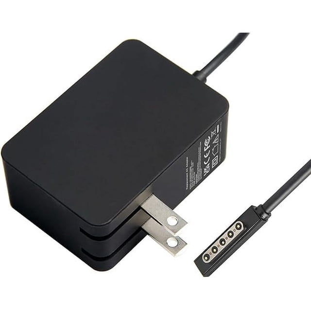 wonima11 24w 12v 2a ac adapter for microsoft surface rt surface pro 1 and surface 2 1512 1513 1516 1572 charger adaptador de corriente negro en vista 3/4, bloque rectangular mate con clavijas plegables tipo A y cable con conector magnético de 5 pines para cargar tablets Surface; también suele usarse como cargador de repuesto portátil para viajes.