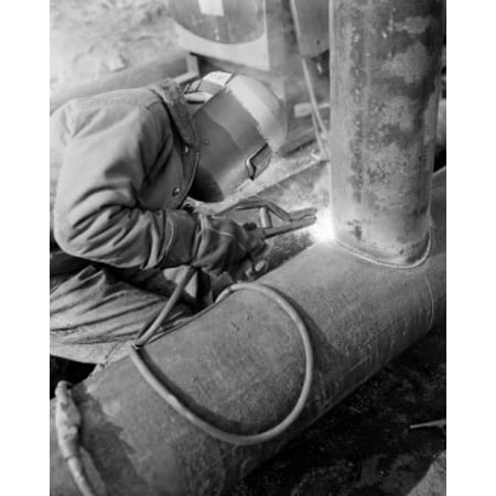 Man in welding mask welding pipe Canvas Art -  (24 x (Best Pipe Welding Helmet)