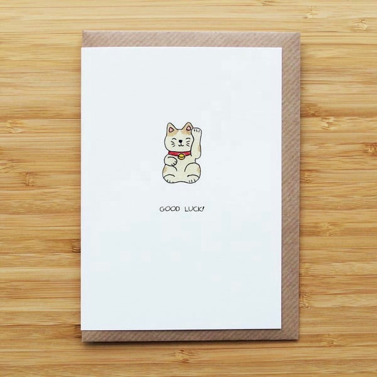 Cute cat illustration card with Good Luck! text perfect for encouraging friends or family on special occasions.