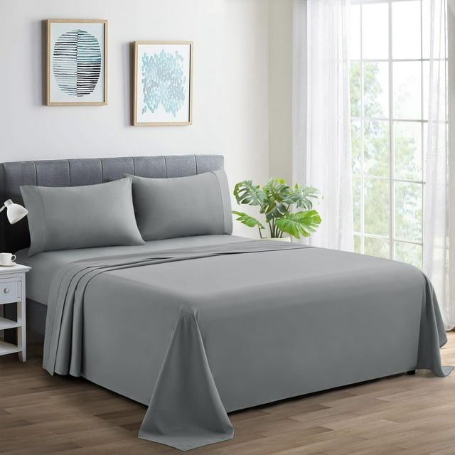 Grey Marina Decoration 600 thread count ultra soft deep pocket percale cotton sheet set displayed on bed with grey upholstered headboard in modern bedroom.