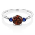 thumbnail image 2 of Gem Stone King 10K White Gold Red Garnet Blue Created Sapphire and White Diamond Accent 3-Stone Engagement Ring for Women (1.14 Cttw, Round 6MM, Gemstone January Birthstone, Size 5), 2 of 5