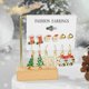 thumbnail image 5 of Juego de pendientes de botón navideños para mujer 2025, pendientes de aro con decoración de alce, árbol de Navidad, muñeco de nieve y luna, joyería para oreja perforada, regalo, 5 of 5