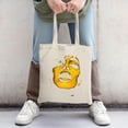 thumbnail image 2 of Stylish Canvas Tote Bag featuring a unique abstract face design in vibrant yellow and white perfect for shopping travel and parties, 2 of 4