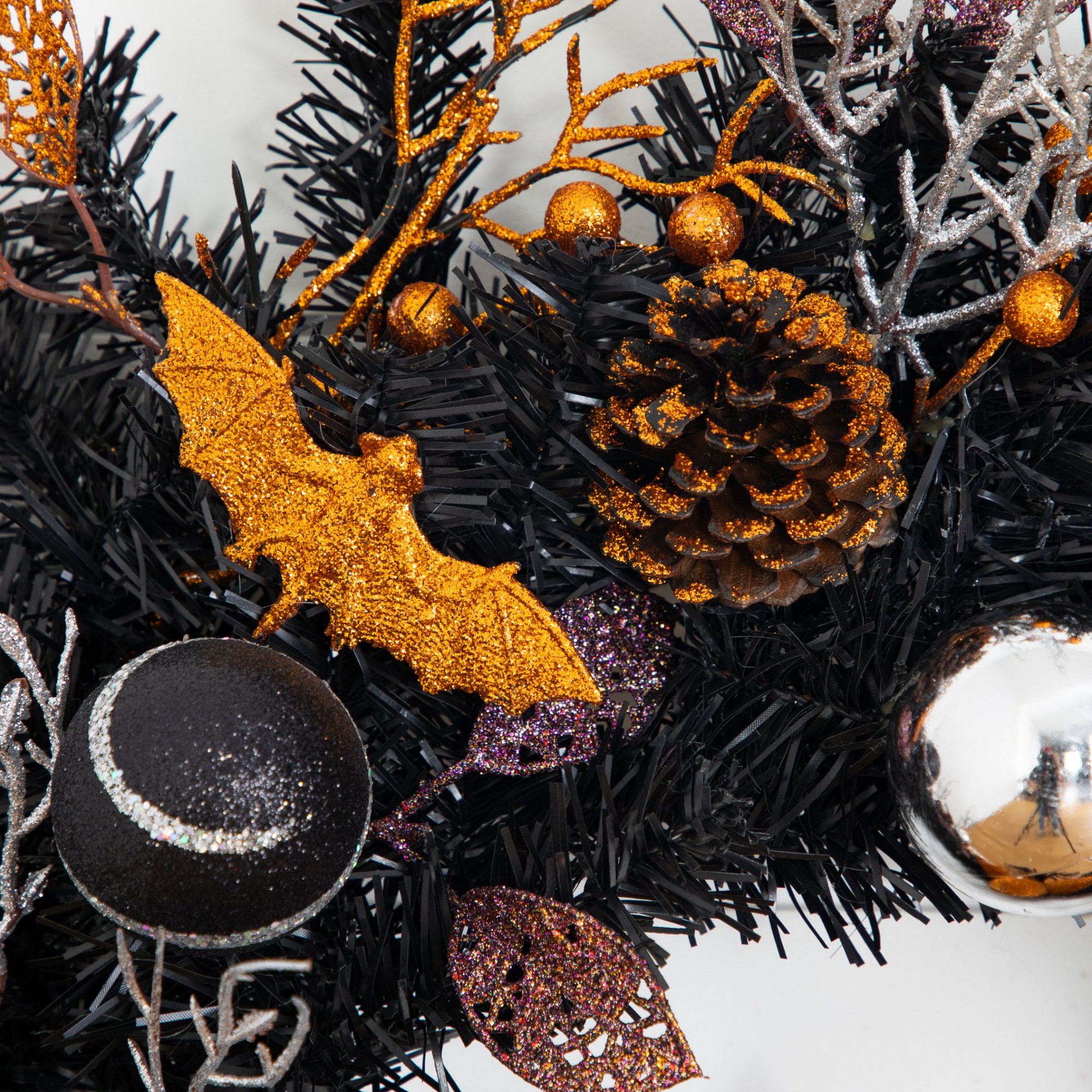 24in. Artificial Halloween Black Mixed Foliage Wreath with Bats, Pinecones and Trees