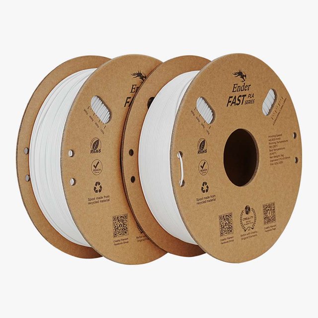 creality ender 2 filamentos pla para impresora 3d fast de 1,75 mm (blanco y blanco) Dos carretes de filamento PLA blanco de 1,75 mm en bobinas de cartón marcadas 'Ender FAST', vista 3/4 frontal que muestra el hilo enrollado, orificios de agarre y textos impresos; especificación de velocidad de impresión 300 mm/s, paquete de 2.