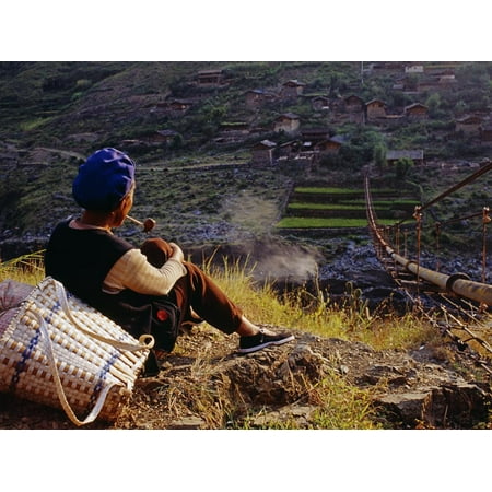Woman Smoking Pipe Smoking Her Pipe, a Naxi Woman Rests after Crossing a Precarious Pipe Bridge High Above the Yangtse Print Wall Art By Amar Grover ()