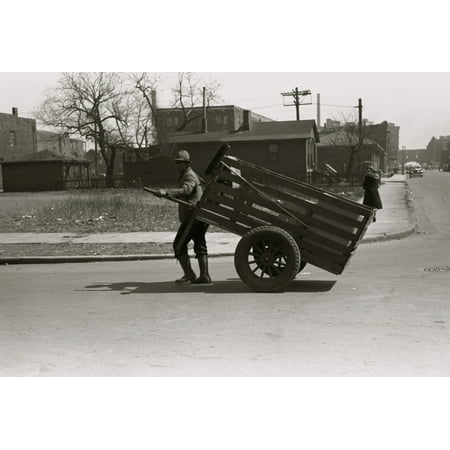 African American pulls a large cart through city streets Poster