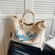 thumbnail image 5 of Bolso de mujer de gran capacidad, superventas 2024, bolso de hombro de lona de color sólido a la moda, bolso de mano de alta calidad con borlas y letras, 5 of 5