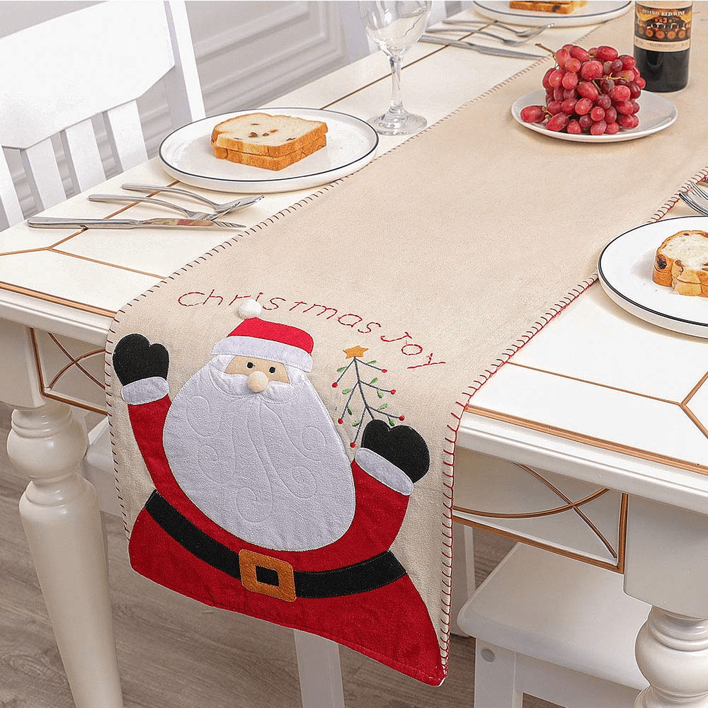 Handmade multicolor quilted cotton Christmas table runner featuring Santa Claus