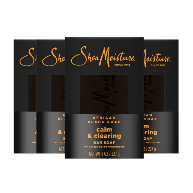 jabón en barra sheamoisture, jabón negro africano, 4 x 113 g, para piel multicolor — Cuatro cajas frontales negras con logo SheaMoisture en naranja; texto central "African Black Soap calm & clearing", ventanilla que revela la barra oscura; empaque menciona avena, aloe y vitamina E y peso neto 8 oz / 227 g. También suele usarse como barra de limpieza corporal para piel seca o problemática según la colección.