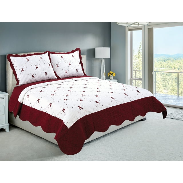 embroidered coverlet bedspread and matching quilted pillow shams in white with burgundy floral pattern and solid burgundy scalloped edges on a bed