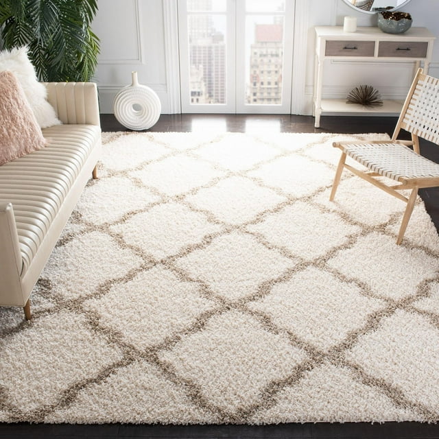 Safavieh Dallas Logan cream shag area rug featuring a light brown geometric diamond pattern, styled in a bright living room with contemporary furniture.