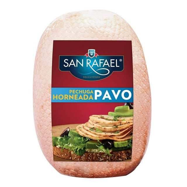 Pechuga de pavo San Rafael horneada por kilo, pieza entera con textura de piel visible, envuelta en plástico con etiqueta roja y azul que muestra el logo San Rafael y una imagen de rebanadas de pavo sobre pan integral con lechuga y aceitunas, baja en grasa y sodio, fuente de proteína ideal para desayunos, snacks o cenas balanceadas.