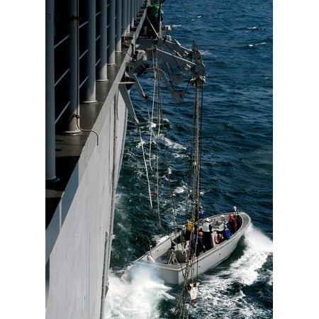 - A Landing Craft Personnel Large is lowered over the side of the amphibious assault ship USS Saipan Poster Print by Stocktrek Images