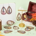 thumbnail image 4 of Kit de 78 piezas para hacer aretes de madera (9 pares) con dijes musicales, instrumentos musicales, guitarras ligeras de madera, arpa, lágrima, grandes, ganchos para aretes, anillos de salto., 4 of 5