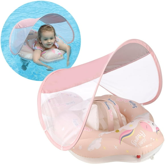 Bebé bebé con toldo rosa que nada sin flotar en la piscina
