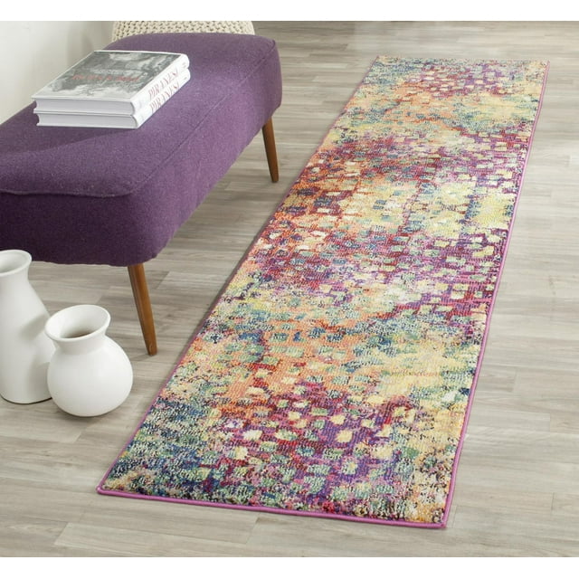 Safavieh Monaco Driskoll abstract area rug in vibrant multicolor pattern displayed on light wood flooring beside a purple upholstered bench with books and white ceramic vases.