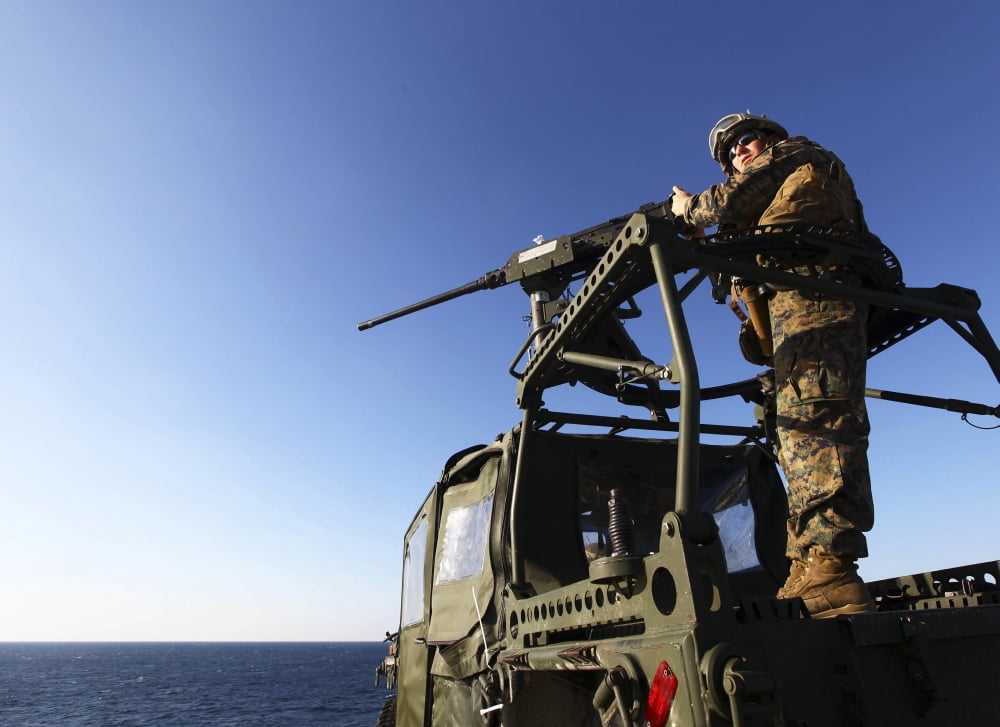 A machine gunner mounts a M-2 50-caliber machine gun on top of a vehicle Canvas Art - Stocktrek Images (33 x 24)