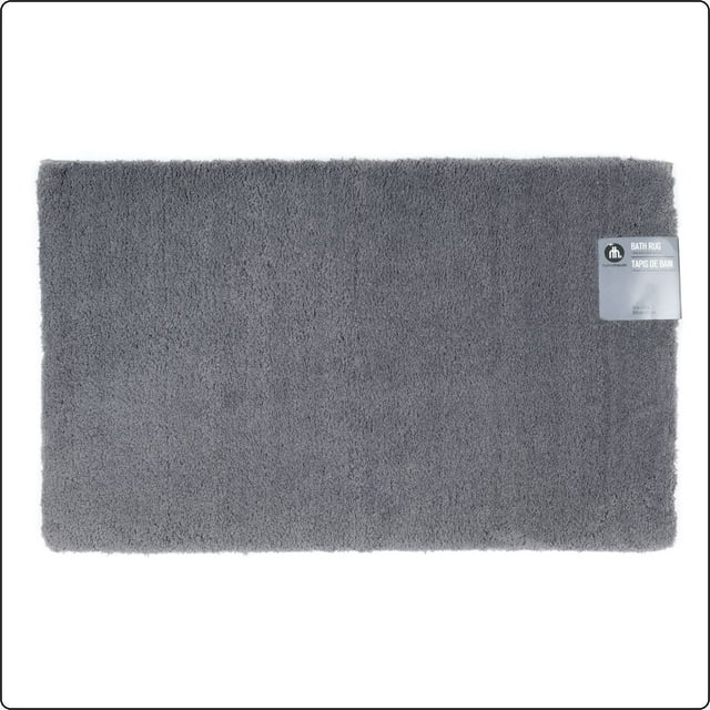 solid dark grey polyester bath rug by Hometrends with a product label attached