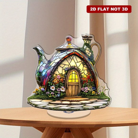 Rotatable acrylic decoration featuring a cute stained glass teapot fairy house with flowers, ivy, and a small door on a decorative garden ground insert