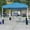 Blue, variant on BizChair 10'x10' Blue Pop Up Canopy Tent with Wheeled Case and 6-Foot Bi-Fold Folding Table with Carrying Handle - Tailgate Tent Set