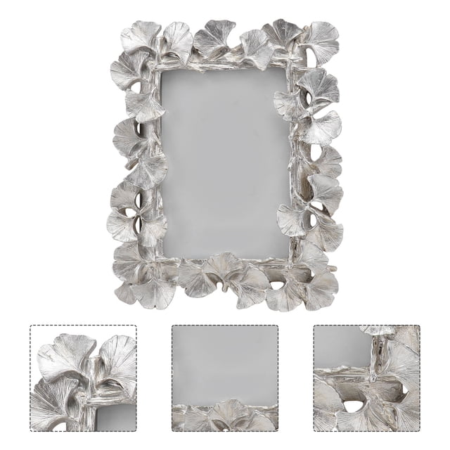 Phenofice wall & tabletop picture frames Photo Frame Silver Glass for Office Decoration 1Set. This vintage-style photo frame features a silver resin and glass construction with intricate floral detailing along the border. Designed with a back easel for stability, it can be placed on a desk, shelf, or dresser. The double-sided transparent frame combines European elegance with modern craftsmanship, making it suitable for bedrooms, living rooms, or offices. Ideal for showcasing cherished memories or as a thoughtful gift.