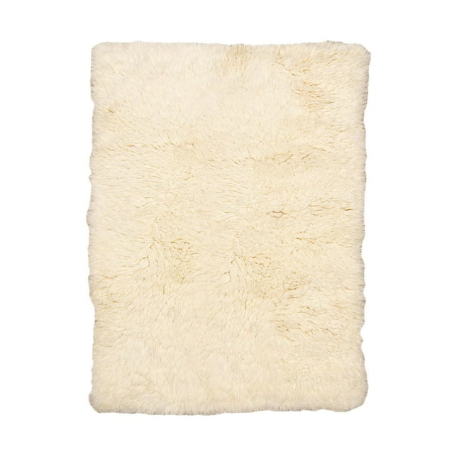 Natural cream-colored Flokati area rug measuring 4 by 6 feet with a dense, plush pile.
