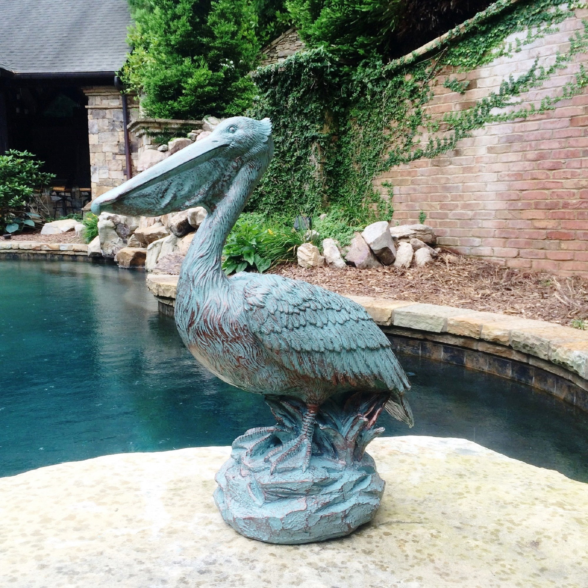 Homestyles 20 in. Bronze Patina Pelican on Coastal Rock Beach Statue